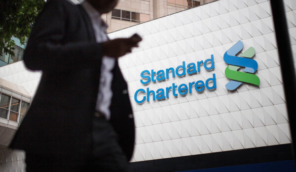 Standard Chartered raises revenue forecast after strong half-year