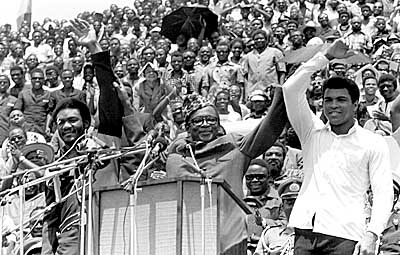 (NY16) (05/16/97_12.11_KINSHASAZAR) FILE--Zaire's President Mobutu Sese Seko, center, raises the arms of heavyweight champ George Foreman, left, and Muhammad Ali on Sept. 20, 1974. Ali defeated Foreman just over a month later during a world championship match. Mobutu gave up power Friday, May 16, 1997, his information minister announced. 'He reigns but does not govern,'' Information Minister Kin-Kiey Mulumba said at a news conference Friday. (AP Photo/Horst Faas)