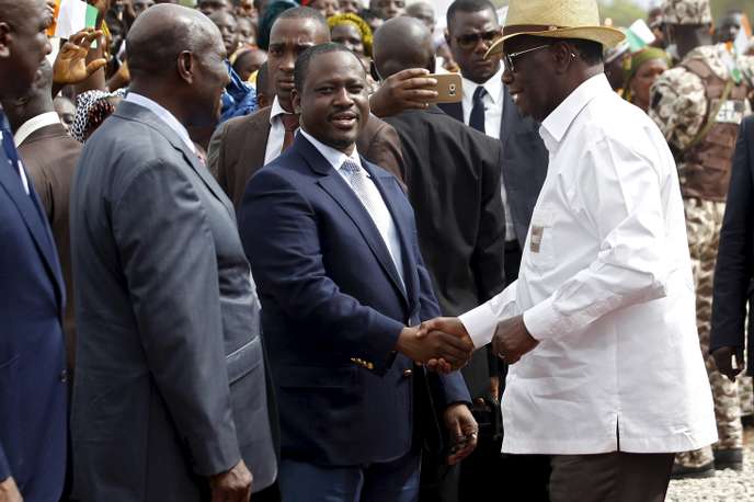 Ivory Coast's President Ouattara shakes hands with Soro Kigbafor President of Ivory Coast parliament during his state visit in the city of Mankono